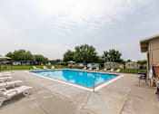 Thumbnail 17 of 21 - Pool With Relaxing Chairs at Heritage Oaks, Nebraska, 68521