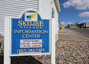 Thumbnail 5 of 5 - A sign for the Skyline Village Information Center with office hours listed.