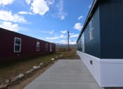 Thumbnail 2 of 8 - a view of the side of a house with a sidewalk in front of it