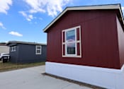 Thumbnail 1 of 8 - the side of a red building with a window and a sidewalk