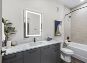 Thumbnail 16 of 50 - a bathroom with mirror and shower bathtub