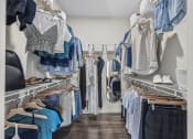 Thumbnail 17 of 50 - a closet with a lot of clothes hanging on a rack