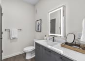 Thumbnail 14 of 50 - a bathroom with a large mirror and a sink and a toilet