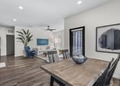 Thumbnail 7 of 50 - a living room and dining room with a wooden table