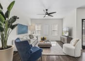 Thumbnail 11 of 50 - a living room with a white couch and a ceiling fan
