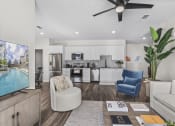 Thumbnail 9 of 50 - an open living room and kitchen with a pool and a ceiling fan