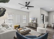 Thumbnail 6 of 50 - a living room with white walls and a ceiling fan