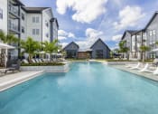 Thumbnail 1 of 50 - a large swimming pool in front of some apartment buildings