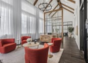 Thumbnail 38 of 50 - the lobby of a hotel with red chairs and a coffee table