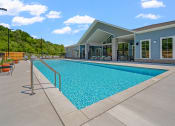 Thumbnail 15 of 76 - a swimming pool with a building in the background at The Lodge  at The Lodge at Overland, Rochester