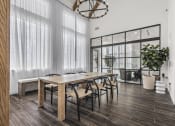 Thumbnail 46 of 50 - a dining room with a long wooden table and chairs