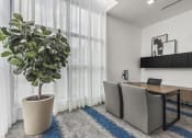Thumbnail 49 of 50 - a home office with a desk and a large plant