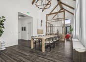 Thumbnail 40 of 50 - a dining room with a wooden table and chairs and a bird cage