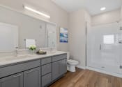 Thumbnail 21 of 57 - a bathroom with a sink and a toilet and a shower