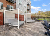 Thumbnail 58 of 62 - a patio with two chairs and a privacy wall at The Aurilla, Minnesota, 55016
