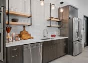 Thumbnail 34 of 76 - a kitchen with gray cabinets and white countertops at The Lodge at Overland, Minnesota