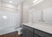 Thumbnail 11 of 57 - a bathroom with a large mirror and a toilet and a shower