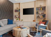 Thumbnail 32 of 76 - a library room filled with furniture and a flat screen tv at The Lodge at Overland, Rochester, MN, 55901