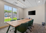 Thumbnail 27 of 76 - a conference room with a large window and a flat screen tv at The Lodge at Overland, Minnesota