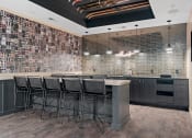 Thumbnail 47 of 76 - a bar with stools in front of a brick wall with a tv on it at The Lodge at Overland, Rochester, MN