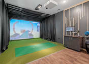 Thumbnail 41 of 76 - a room with a golf simulator and a large screen on the wall at The Lodge at Overland, Rochester, MN, 55901
