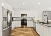 Thumbnail 20 of 50 - Luxurious Kitchen with White Cabinets at Azalea Luxury Apartments, Tampa, FL