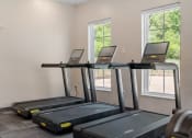 Thumbnail 54 of 76 - a room with three treadmills at The Lodge at Overland, Minnesota