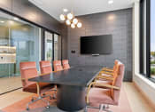 Thumbnail 39 of 57 - a conference room with a long table and chairs and a television