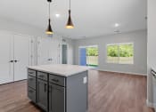 Thumbnail 58 of 76 - a kitchen and living room in a new home with a large island at The Lodge at Overland, Rochester, Minnesota