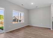 Thumbnail 63 of 76 - a bedroom with a large window and hardwood floors at The Lodge at Overland, Rochester, MN, 55901