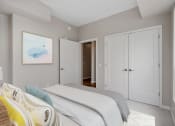 Thumbnail 23 of 57 - a bedroom with a large bed and a door to a hallway