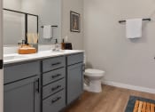 Thumbnail 8 of 76 - a bathroom with a toilet and a sink and a mirror at The Lodge at Overland, Minnesota, 55901