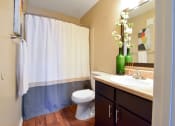 Thumbnail 28 of 43 - a bathroom with a toilet sink and shower  at Riverset Apartments, Tennessee, 38103