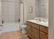 Thumbnail 8 of 62 - a bathroom with a sink and a toilet and a shower at The Aurilla in Cottage Grove, Minnesota