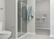 Thumbnail 11 of 30 - a small bathroom with a shower and a toilet at Park 205, Park Ridge, 60068