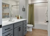 Thumbnail 11 of 76 - a bathroom with a sink and a toilet and a shower at The Lodge at Overland, Rochester