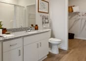 Thumbnail 16 of 42 - a bathroom with a sink and a toilet and a shower at The View on Collins, Lansing, MI