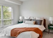 Thumbnail 10 of 62 - a bedroom with a bed and a large window at The Aurilla in Cottage Grove, MN