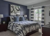 Thumbnail 5 of 30 - a bedroom with navy blue walls and a bed with blue and white comforter