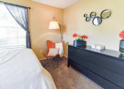 Thumbnail 23 of 43 - a bedroom with a bed and a dresser  at Riverset Apartments, Memphis