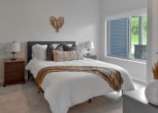 Thumbnail 9 of 76 - a bedroom with a large bed and a window at The Lodge at Overland, Rochester, Minnesota