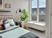 Thumbnail 9 of 57 - a bedroom with a bed and a large window