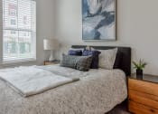 Thumbnail 13 of 42 - a bedroom with a bed and a dresser and a window  at The View on Collins, Lansing, 48910