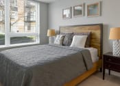 Thumbnail 5 of 30 - a bedroom with a bed and a large window at Park 205, Park Ridge, IL