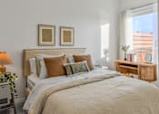 Thumbnail 75 of 83 - A bedroom with a large bed and two framed pictures on the wall.