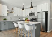 Thumbnail 67 of 76 - a modern kitchen with white cabinets and stainless steel appliances at The Lodge at Overland, Rochester, Minnesota