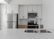 Thumbnail 25 of 83 - A brand new designer kitchen at The Hallon II luxury apartments in Hopkins, MN
