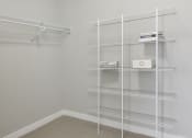 Thumbnail 9 of 30 - a white closet with white shelves and wire shelving in it at Park 205, Illinois, 60068