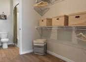 Thumbnail 6 of 76 - a bathroom with a toilet and a closet with boxes on the wall and a basket at The Lodge at Overland, Rochester, MN