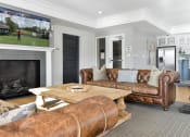 Thumbnail 29 of 30 - a living room with leather couches and a fireplace at Park 205, Illinois, 60068